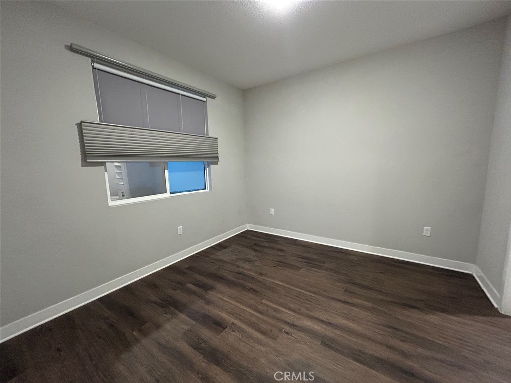 2111 Copper Walk Gardena, CA 90249 - Photo 27 of 33 a view of an empty room with wooden floor and a window