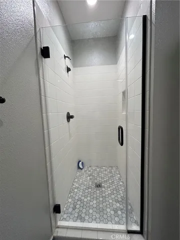 a kitchen with stainless steel appliances a dining table chairs and a wooden floor