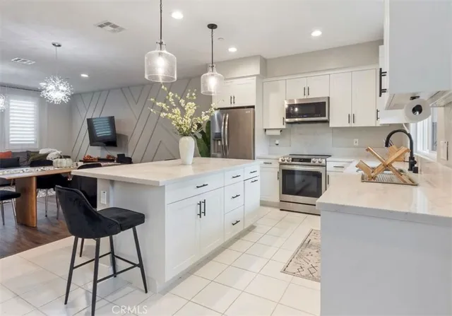a kitchen with cabinets stainless steel appliances and sink