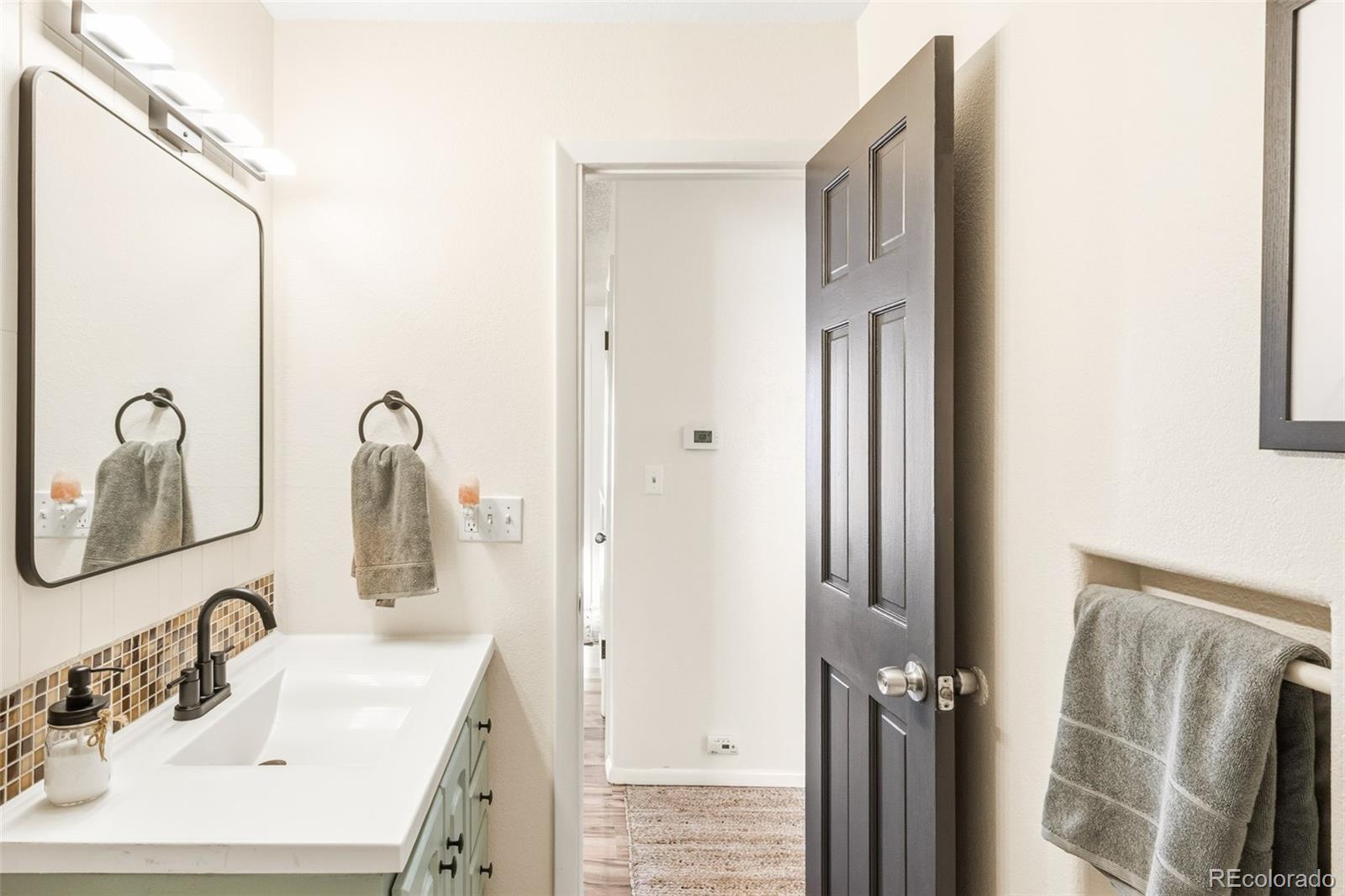 2102 Ridge Drive Broomfield, CO 80020 - Photo 15 of 35 a bathroom with a sink and mirror