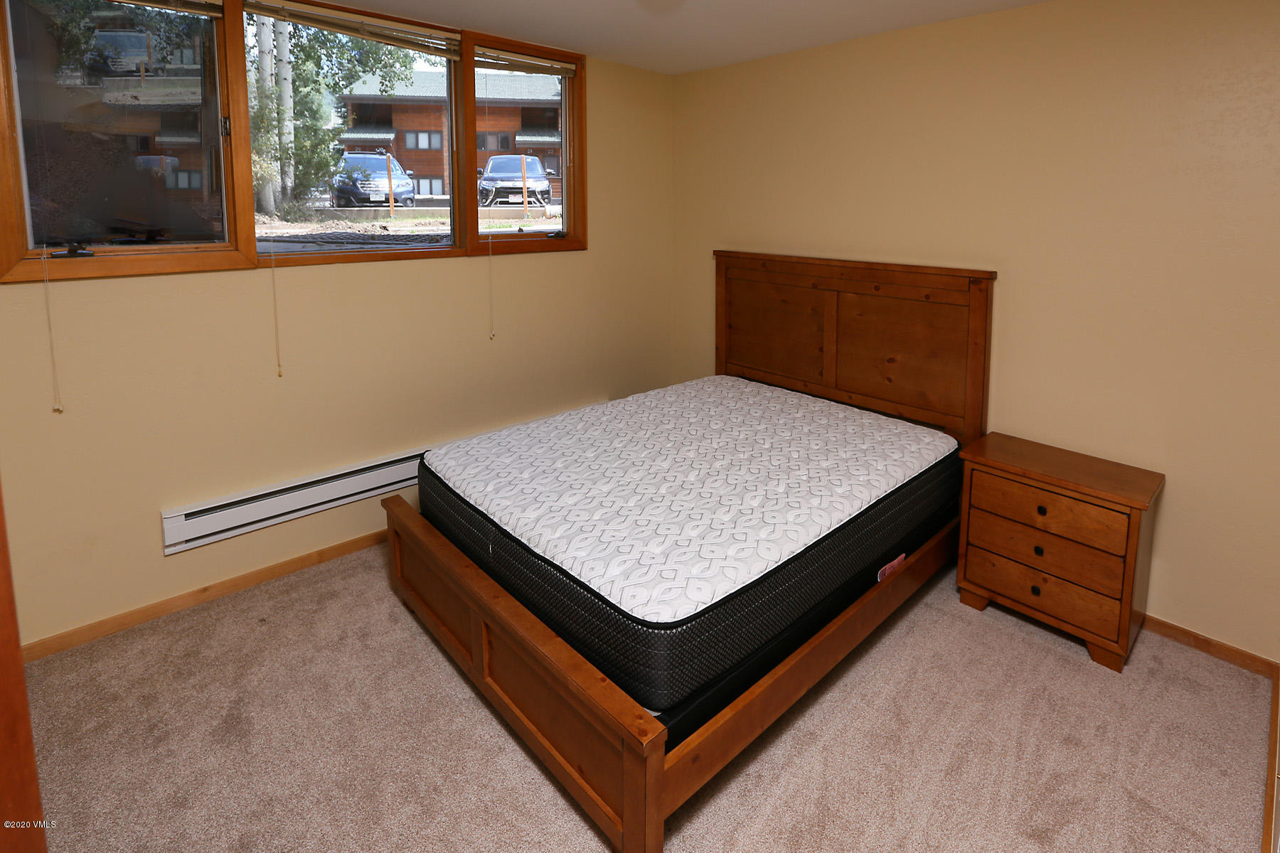 54 Columbine Circle, Unit A5 Eagle-Vail, CO 81620 - Photo 15 of 23 a bed sitting in a bedroom next to a window