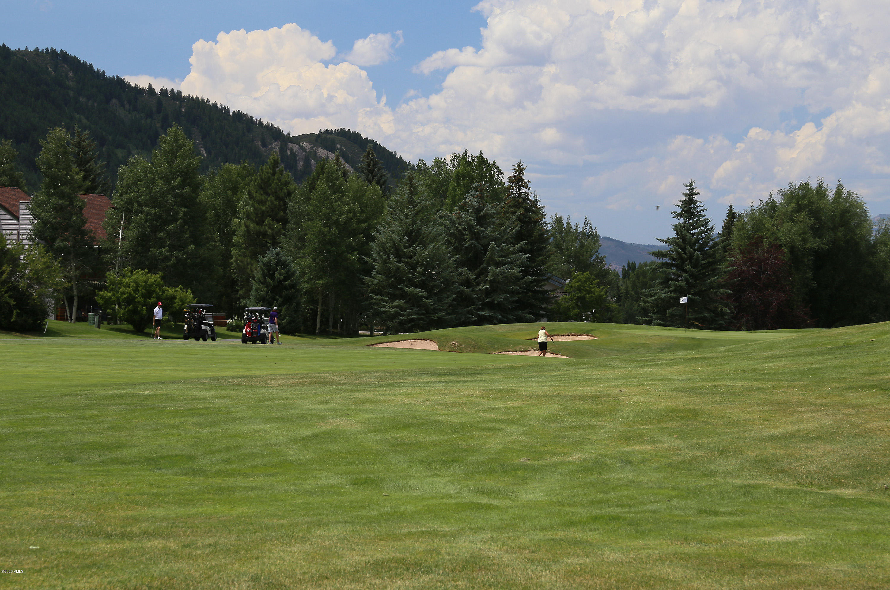 54 Columbine Circle, Unit A5 Eagle-Vail, CO 81620 - Photo 20 of 23 a view of a golf course with a lake