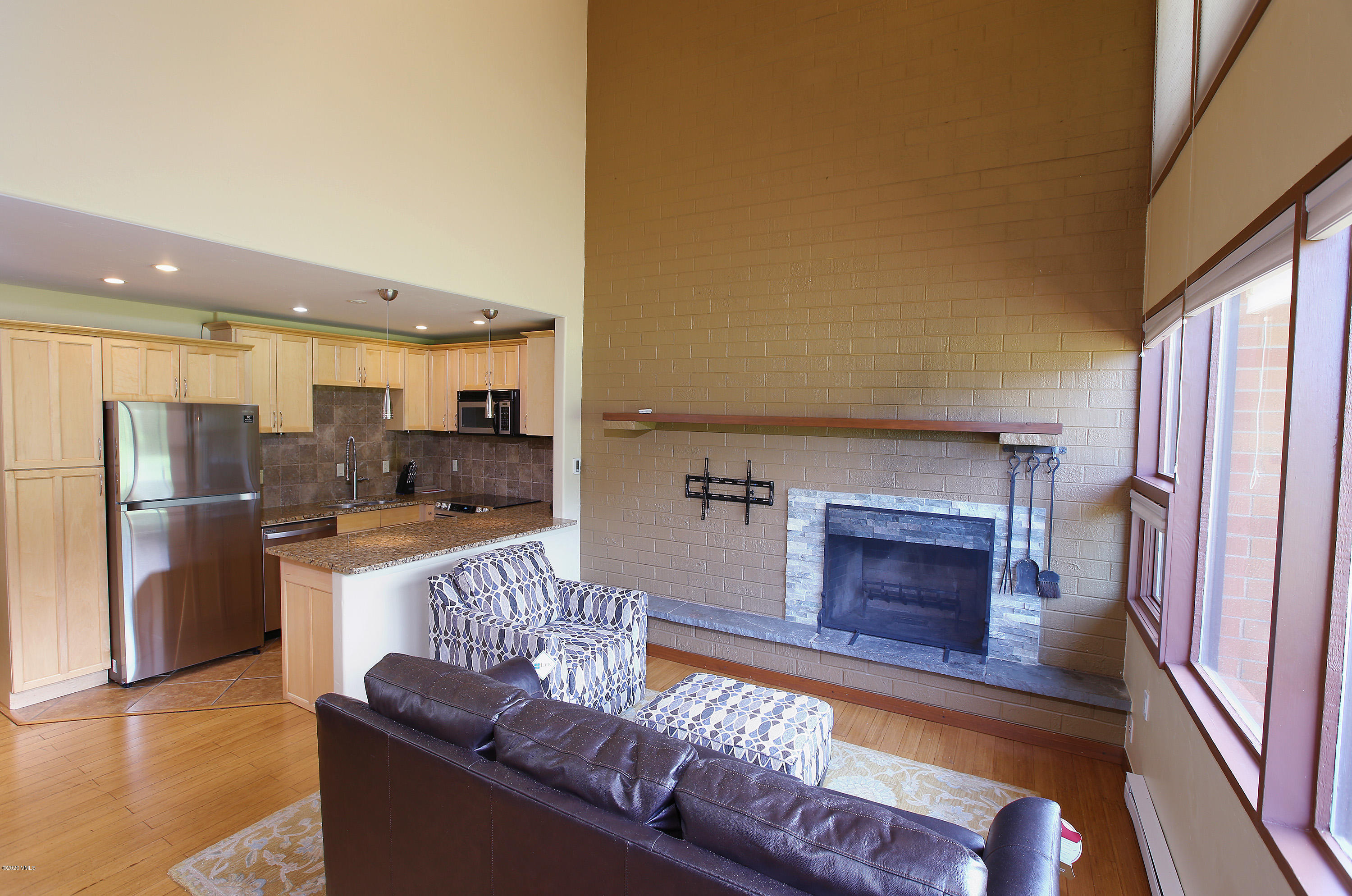 54 Columbine Circle, Unit A5 Eagle-Vail, CO 81620 - Photo 4 of 23 a living room with stainless steel appliances furniture a fireplace and a kitchen view