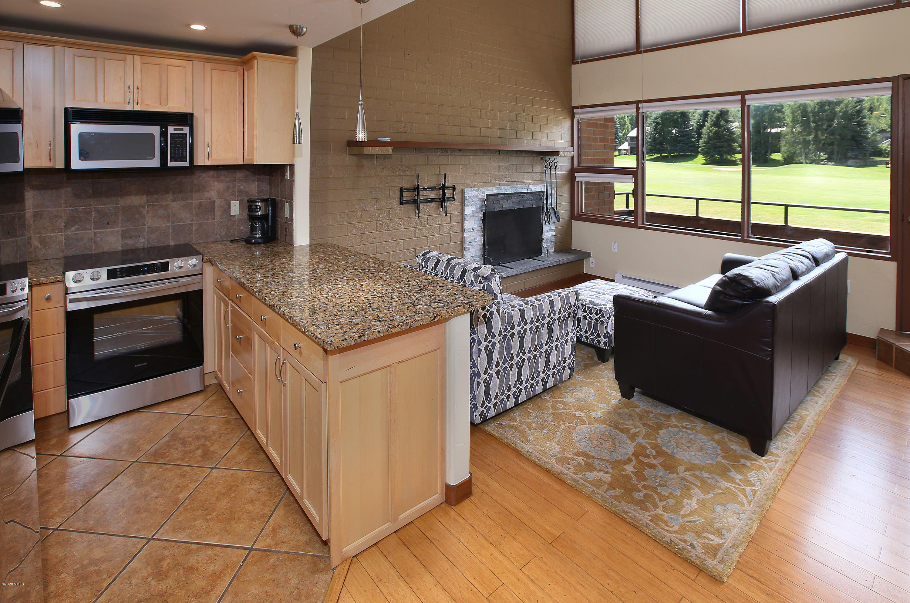 54 Columbine Circle, Unit A5 Eagle-Vail, CO 81620 - Photo 6 of 23 a kitchen with stainless steel appliances granite countertop a stove a sink and a microwave