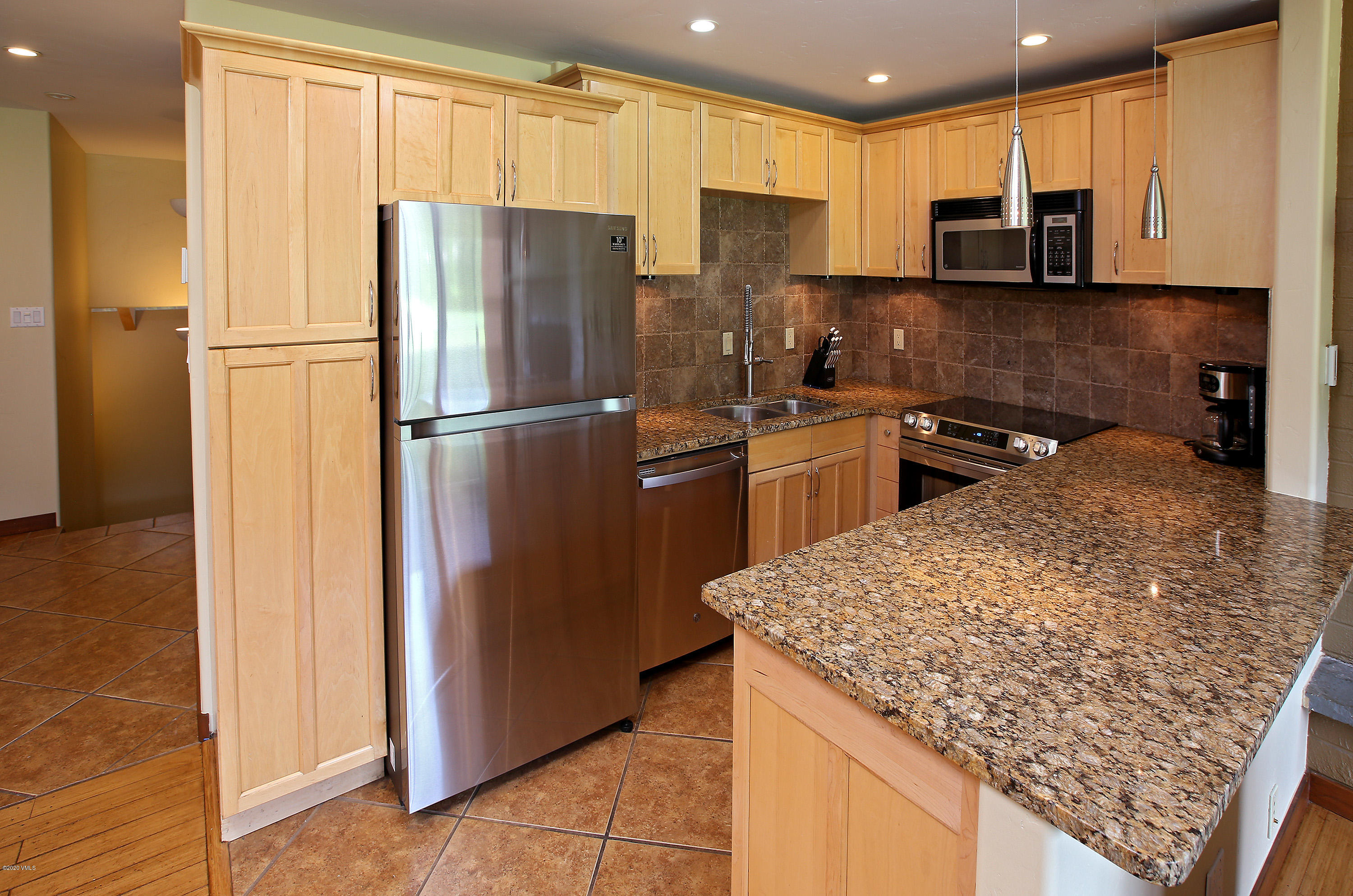 54 Columbine Circle, Unit A5 Eagle-Vail, CO 81620 - Photo 8 of 23 a kitchen with a refrigerator sink and microwave
