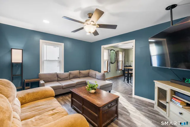 a living room with furniture and a flat screen tv