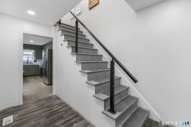 a view of entryway and hall with wooden floor
