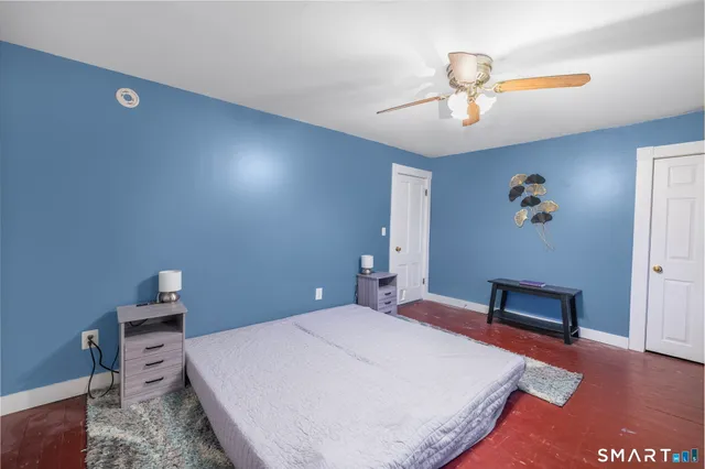 a bedroom with a bed and a chandelier