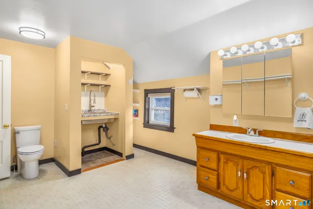 a spacious bathroom with a sink toilet and a mirror