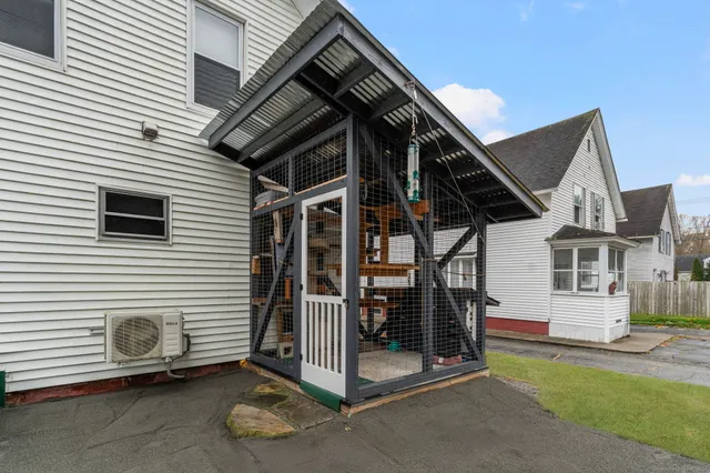 a view of a house with backyard and porch
