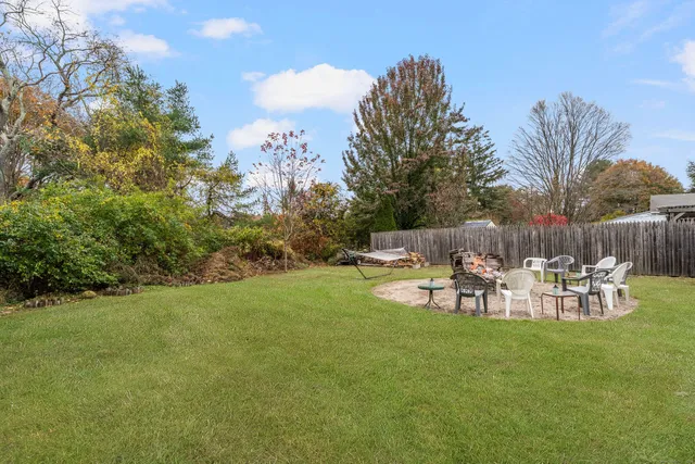 a view of backyard with seating area and green space