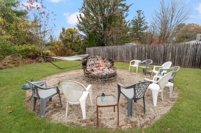 a backyard of a house with table and chairs