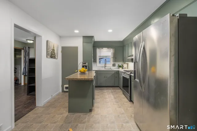 a kitchen with a sink stainless steel appliances and cabinets