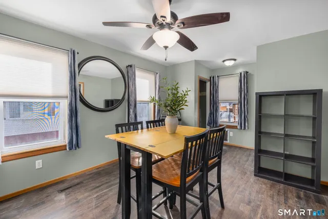 a view of a dining room with furniture a chandelier and wooden floor