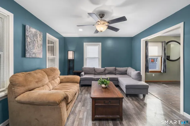 a living room with furniture and wooden floor