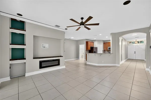 an empty room with a chandelier fan