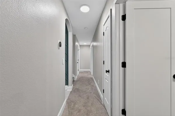 a view of an empty room with a chandelier