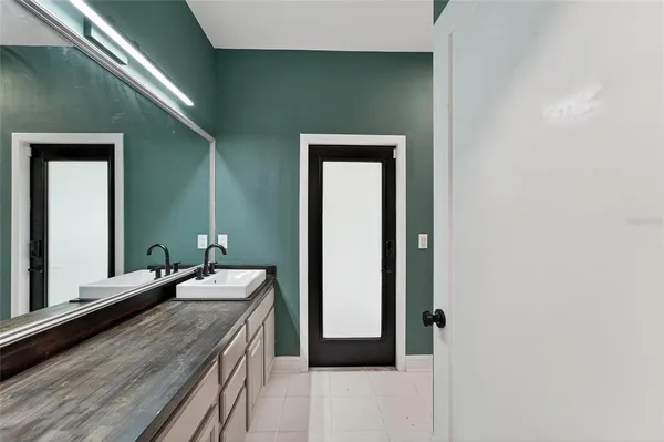 a bathroom with a sink a toilet and mirror