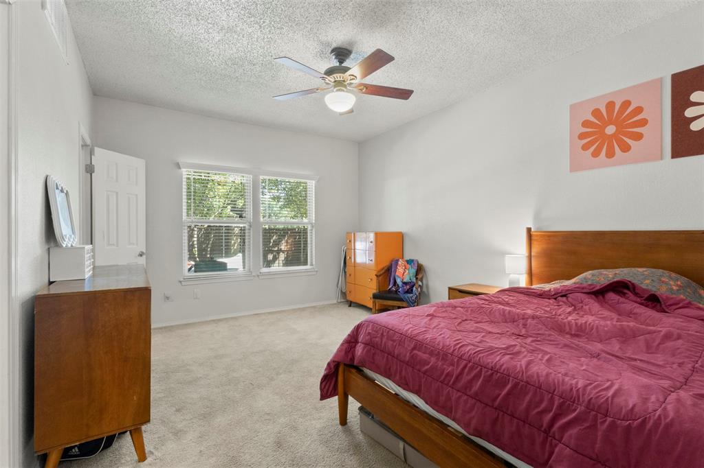 5616 Preston Oaks Road, Unit 1105 Dallas, TX 75254 - Photo 11 of 17 a bed room with a bed and a television