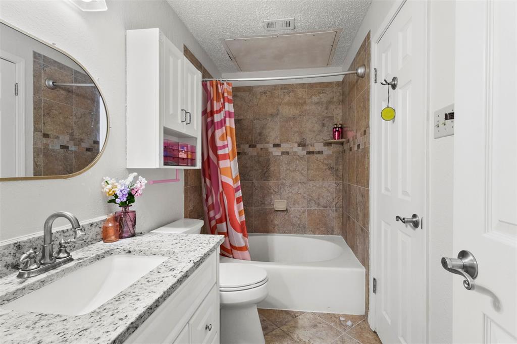 5616 Preston Oaks Road, Unit 1105 Dallas, TX 75254 - Photo 13 of 17 a bathroom with a granite countertop sink toilet and shower