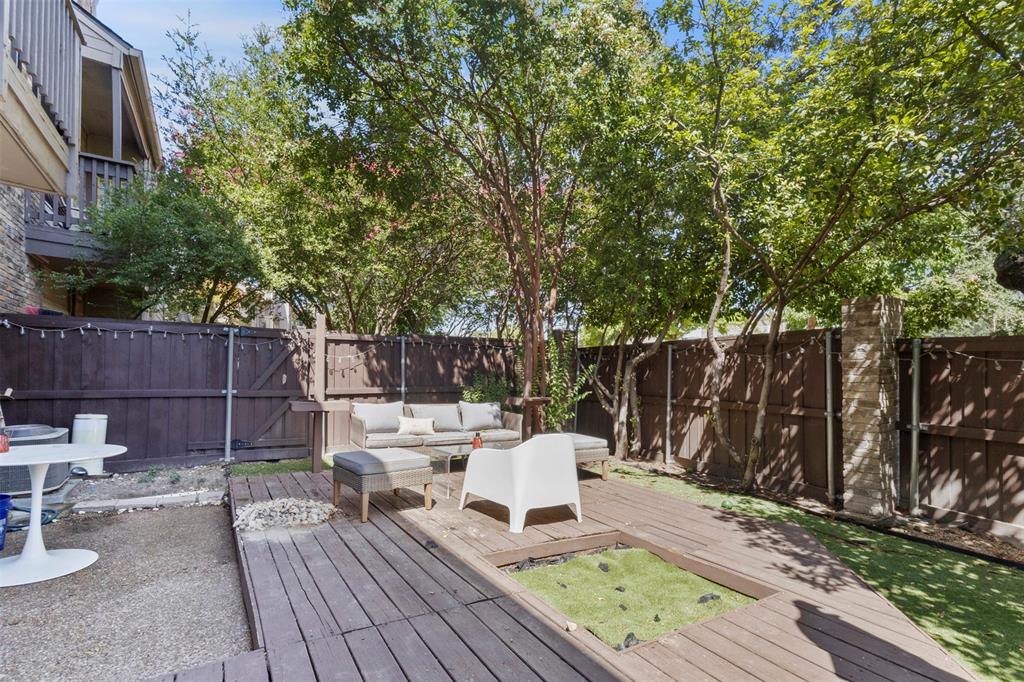 5616 Preston Oaks Road, Unit 1105 Dallas, TX 75254 - Photo 14 of 17 a view of a deck with furniture and garden
