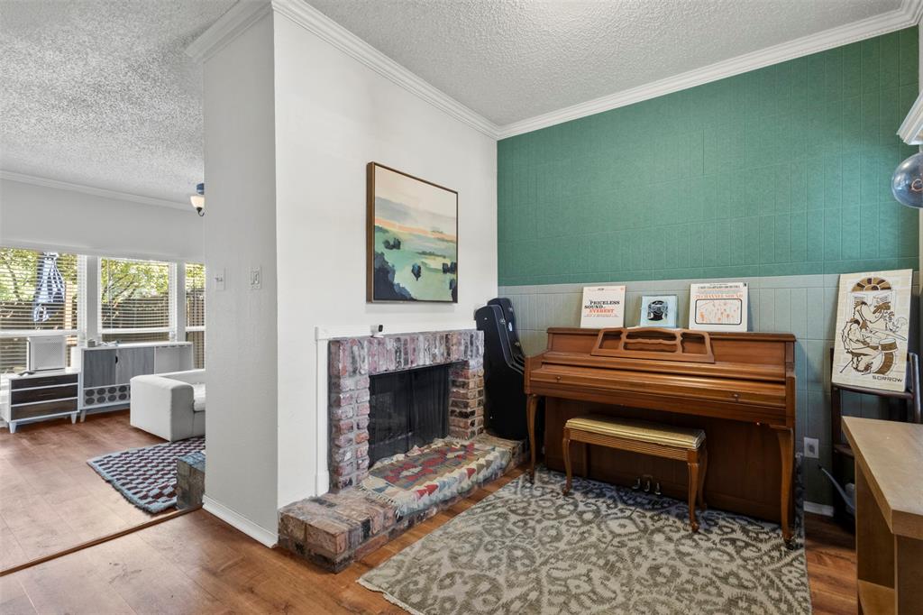 5616 Preston Oaks Road, Unit 1105 Dallas, TX 75254 - Photo 4 of 17 a living room with furniture and a fireplace