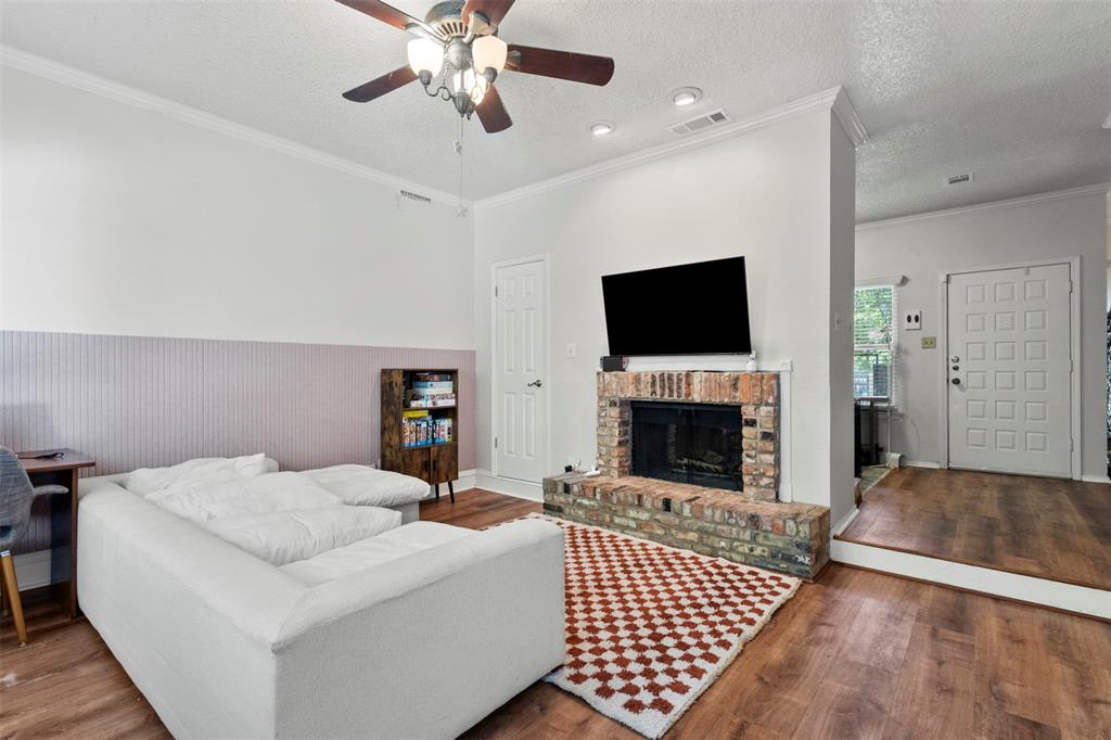 5616 Preston Oaks Road, Unit 1105 Dallas, TX 75254 - Photo 5 of 17 a living room with furniture and a fireplace
