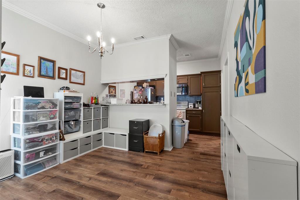 5616 Preston Oaks Road, Unit 1105 Dallas, TX 75254 - Photo 8 of 17 a view of a kitchen with cabinets and wooden floor
