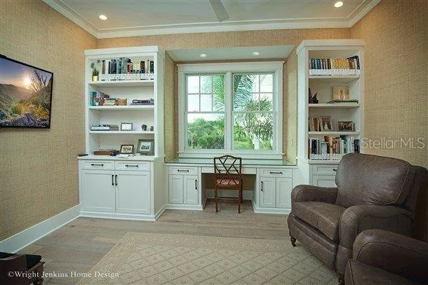 a living room with furniture a window and a flat screen tv