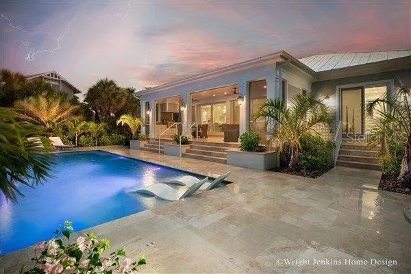 a view of a house with backyard porch and sitting area