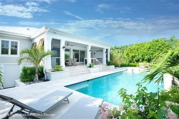 a view of a backyard with plants and swimming pool