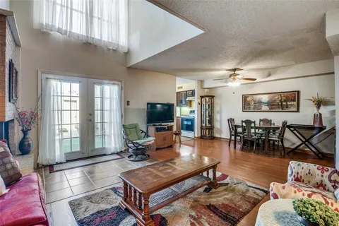 a living room with furniture a flat screen tv and a large window