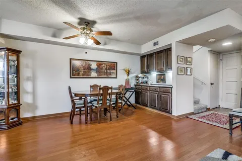 a view of a dining room with furniture and chandelier