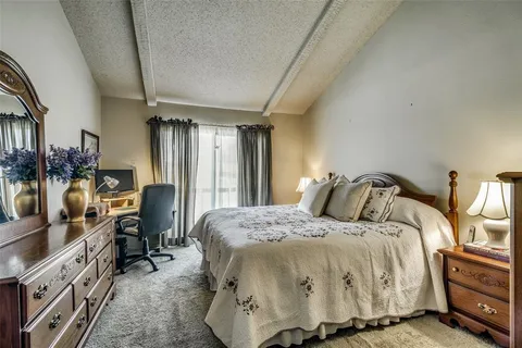 a bedroom with a bed a couch and dresser