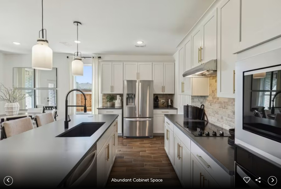 312 Celeste Way Liberty Hill, TX 78642 - Photo 6 of 15 a large kitchen with stainless steel appliances a stove sink and white cabinets