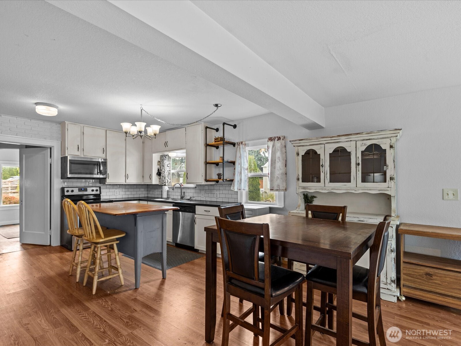 6507 Cady Road Everett, WA 98203 - Photo 16 of 29 a view of a dining room with furniture and wooden floor
