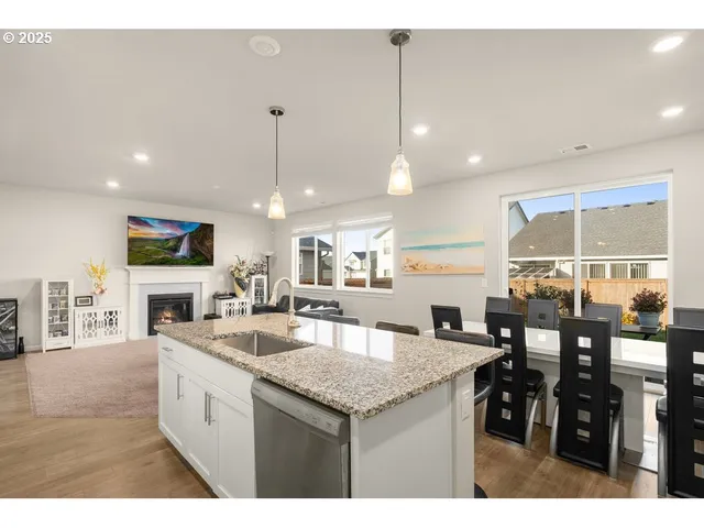 a kitchen with stainless steel appliances granite countertop a kitchen island a stove and a sink