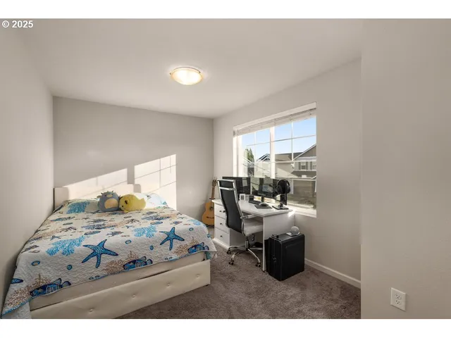 a bedroom with a bed and large windows