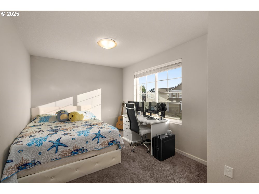 6421 Southeast 22nd Street Gresham, OR 97080 - Photo 17 of 39 a bedroom with a bed and large windows