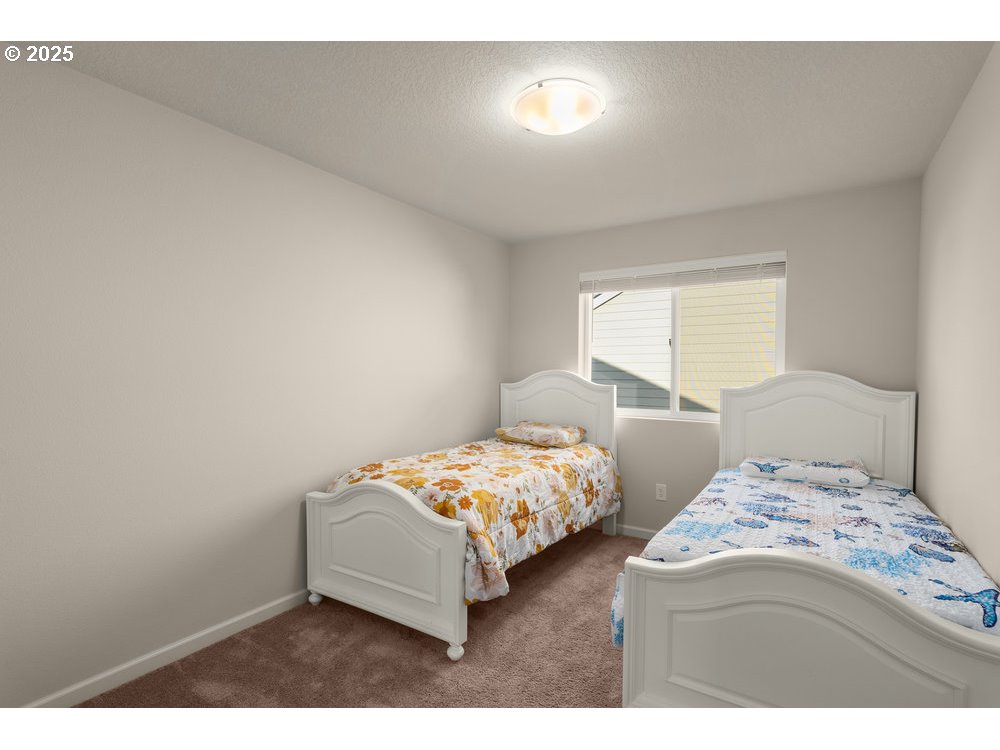6421 Southeast 22nd Street Gresham, OR 97080 - Photo 18 of 39 a bedroom with two bed and window