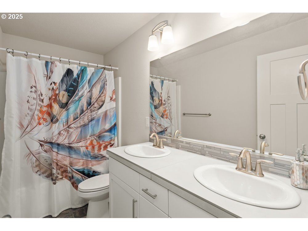 6421 Southeast 22nd Street Gresham, OR 97080 - Photo 19 of 39 a bathroom with a granite countertop sink a toilet and a mirror