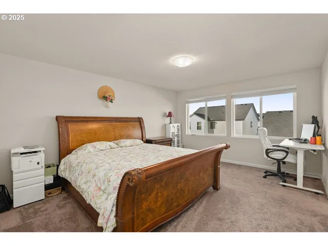 a bedroom with a bed and a table in it