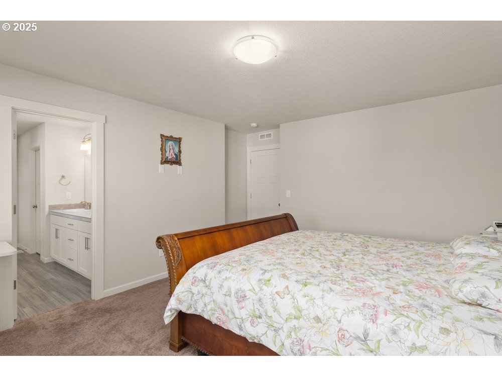 6421 Southeast 22nd Street Gresham, OR 97080 - Photo 22 of 39 a bedroom with a bed and a cabinets