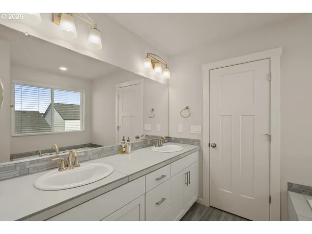 a bathroom with a sink double vanity and a mirror