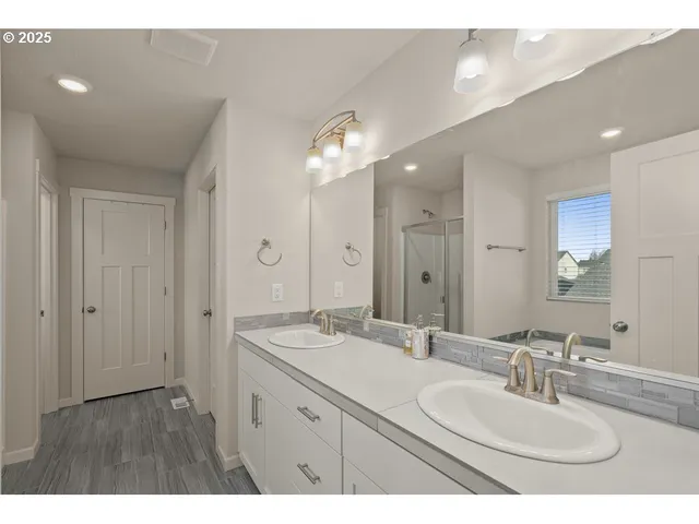 a bathroom with a double vanity sink mirror and double