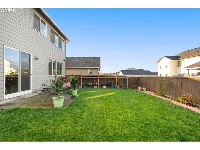 a backyard of a house with table and chairs