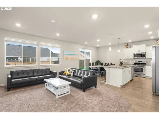 a living room with furniture and kitchen view