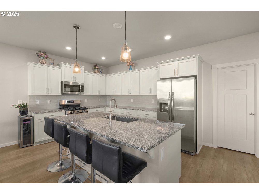 6421 Southeast 22nd Street Gresham, OR 97080 - Photo 8 of 39 a kitchen with stainless steel appliances granite countertop a sink a stove and a refrigerator