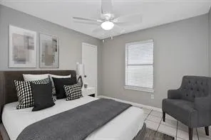 a bedroom with a bed and a couch