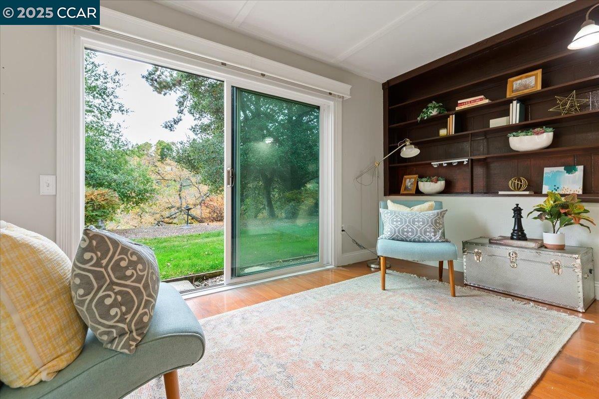 1857 Golden Rain Road, Unit 2 Walnut Creek, CA 94595 - Photo 13 of 39 a living room with furniture and a floor to ceiling window